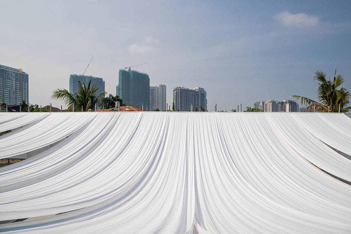 MIA Design Studio's Ashui Pavilion is made of white layers of fabric creating soft curve in Vietnam 
