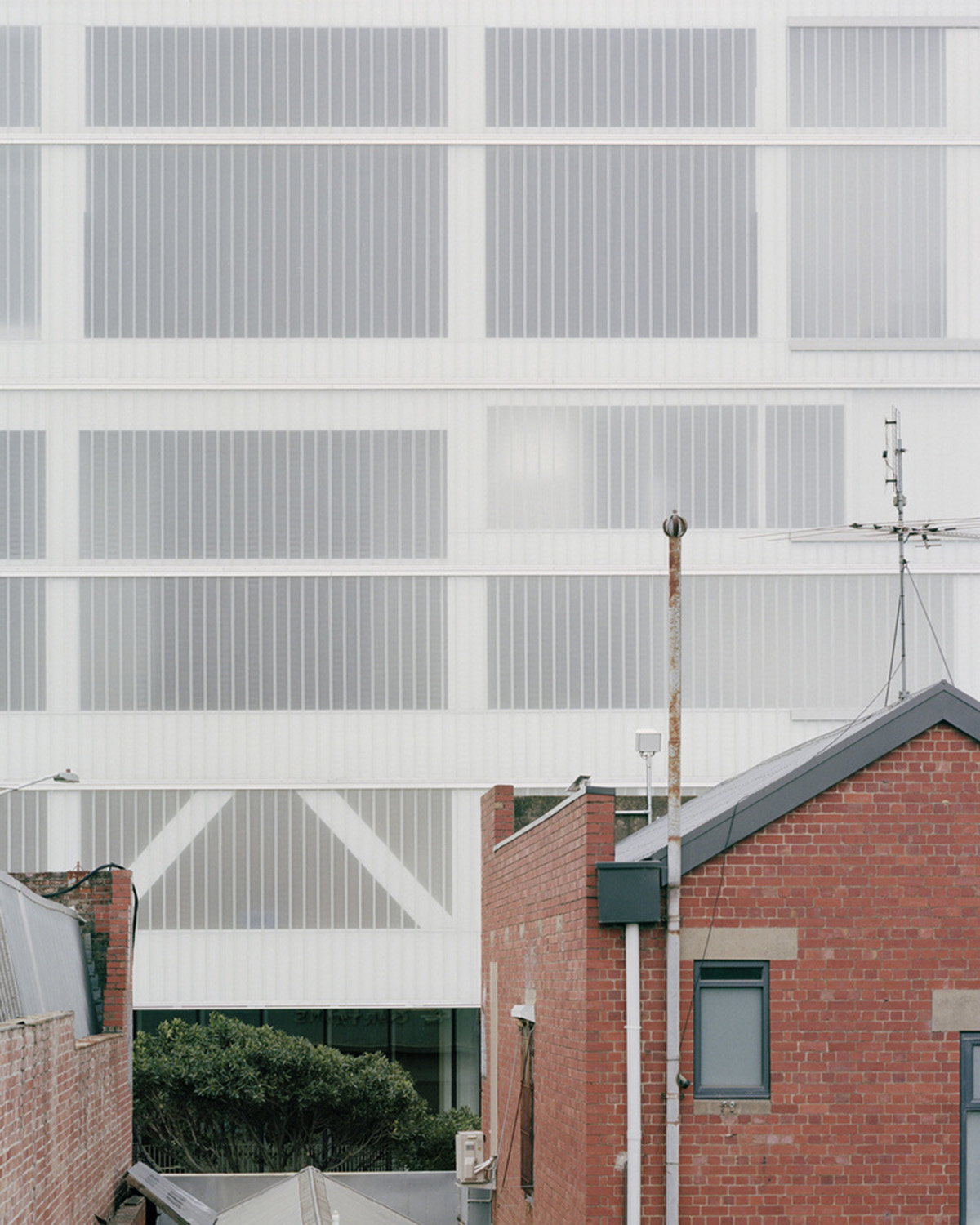 Hassell reveals Arts Centre with sliced translucent volume which is in dialogue with historic church