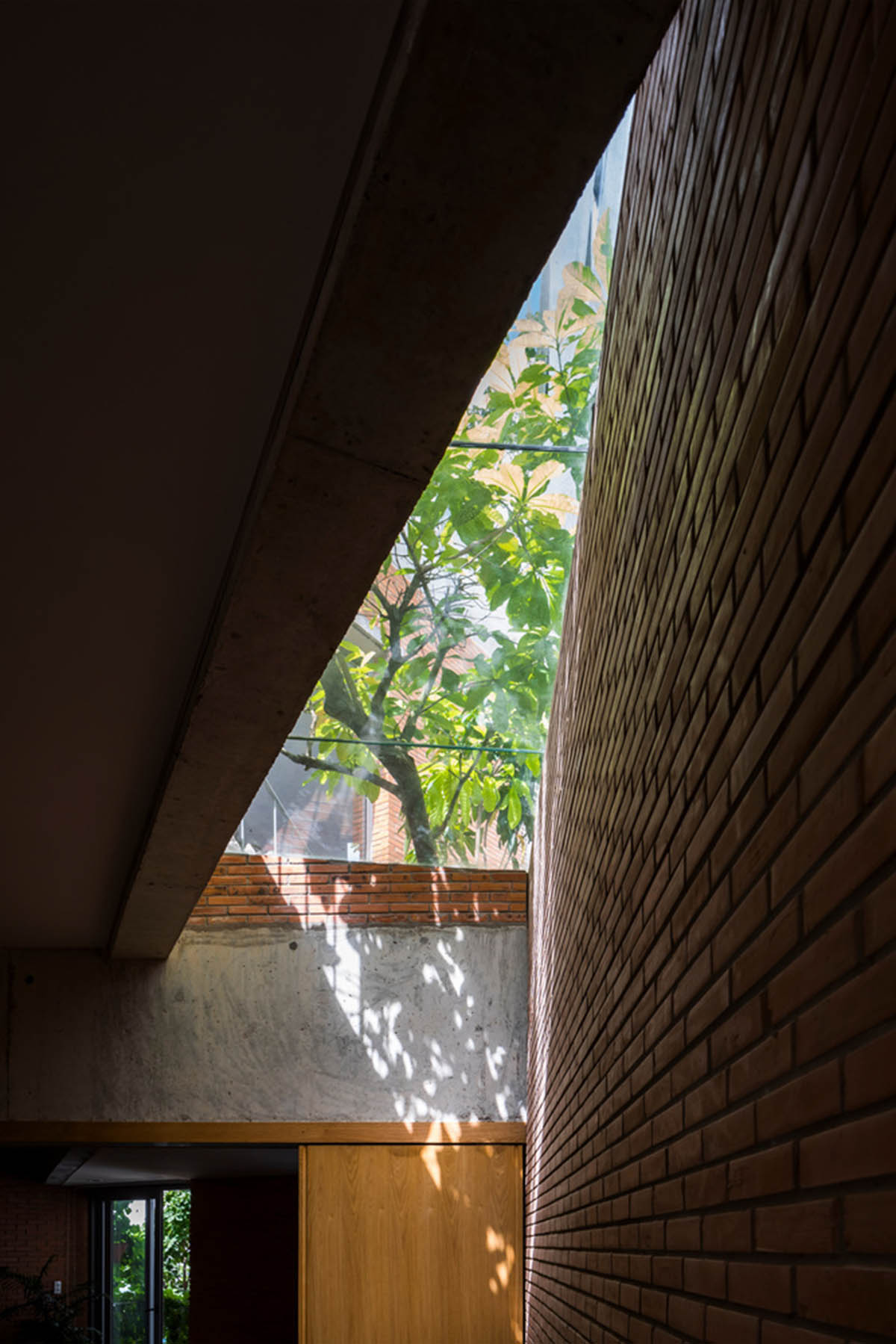 VTN Architects' new cascading family house creates large green gardens in a narrow site of Vietnam