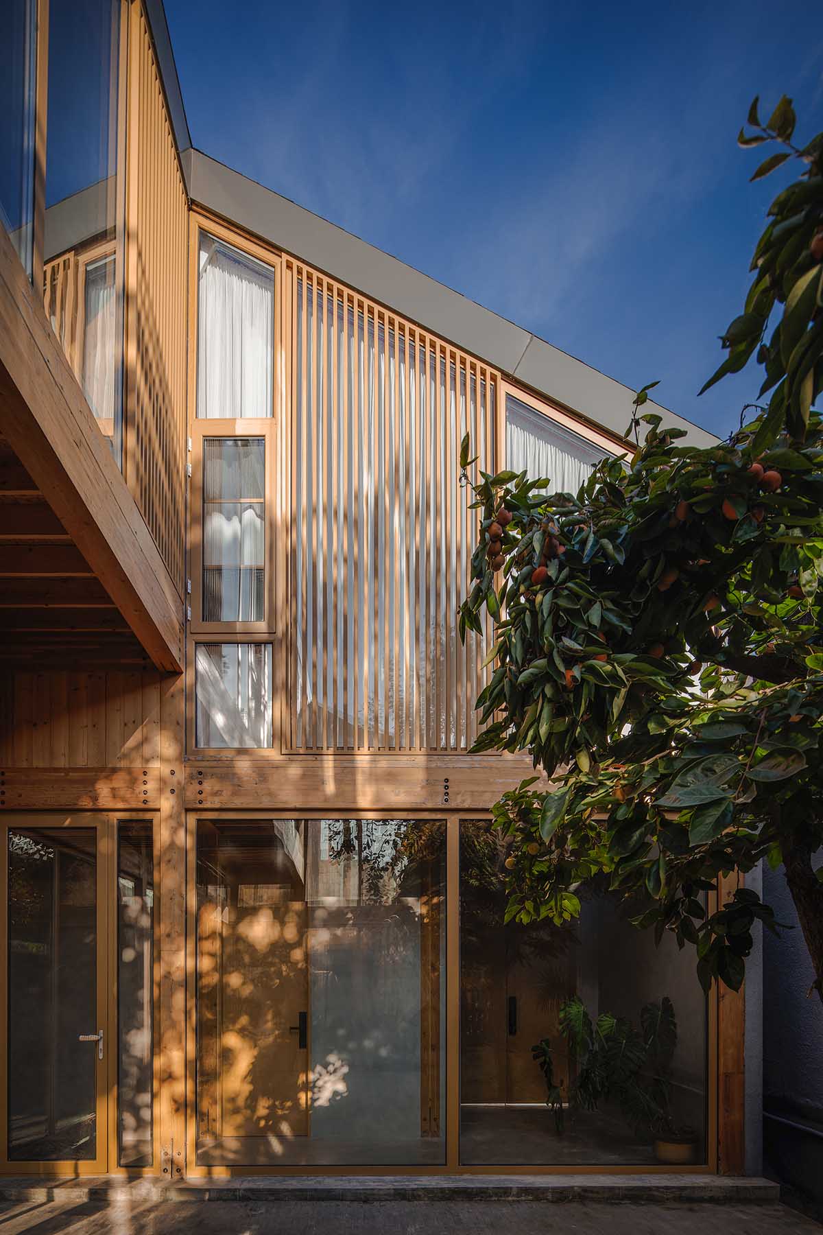 Archstudio renovates traditional Beijing courtyard house with interwoven wooden framework