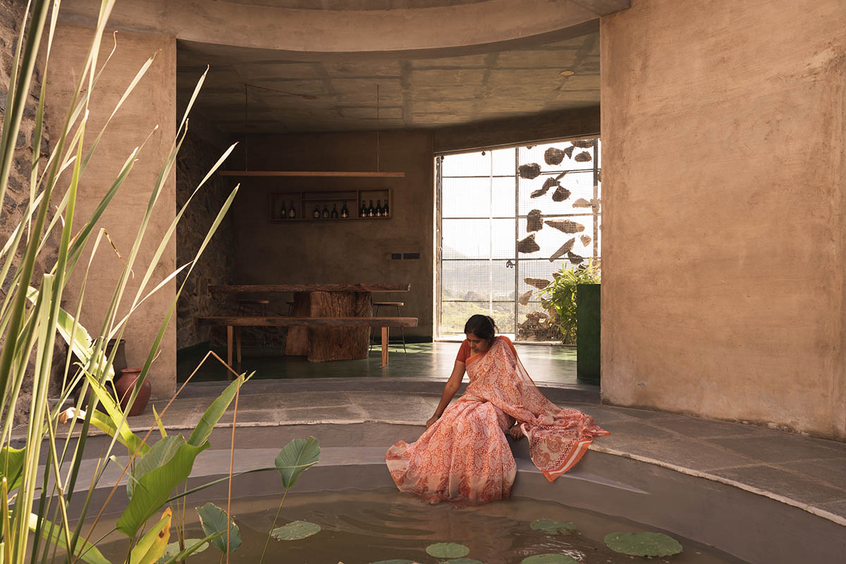 Farm house by Earthscape Studio is wrapped by gabion wall to filter light and airflow in India 