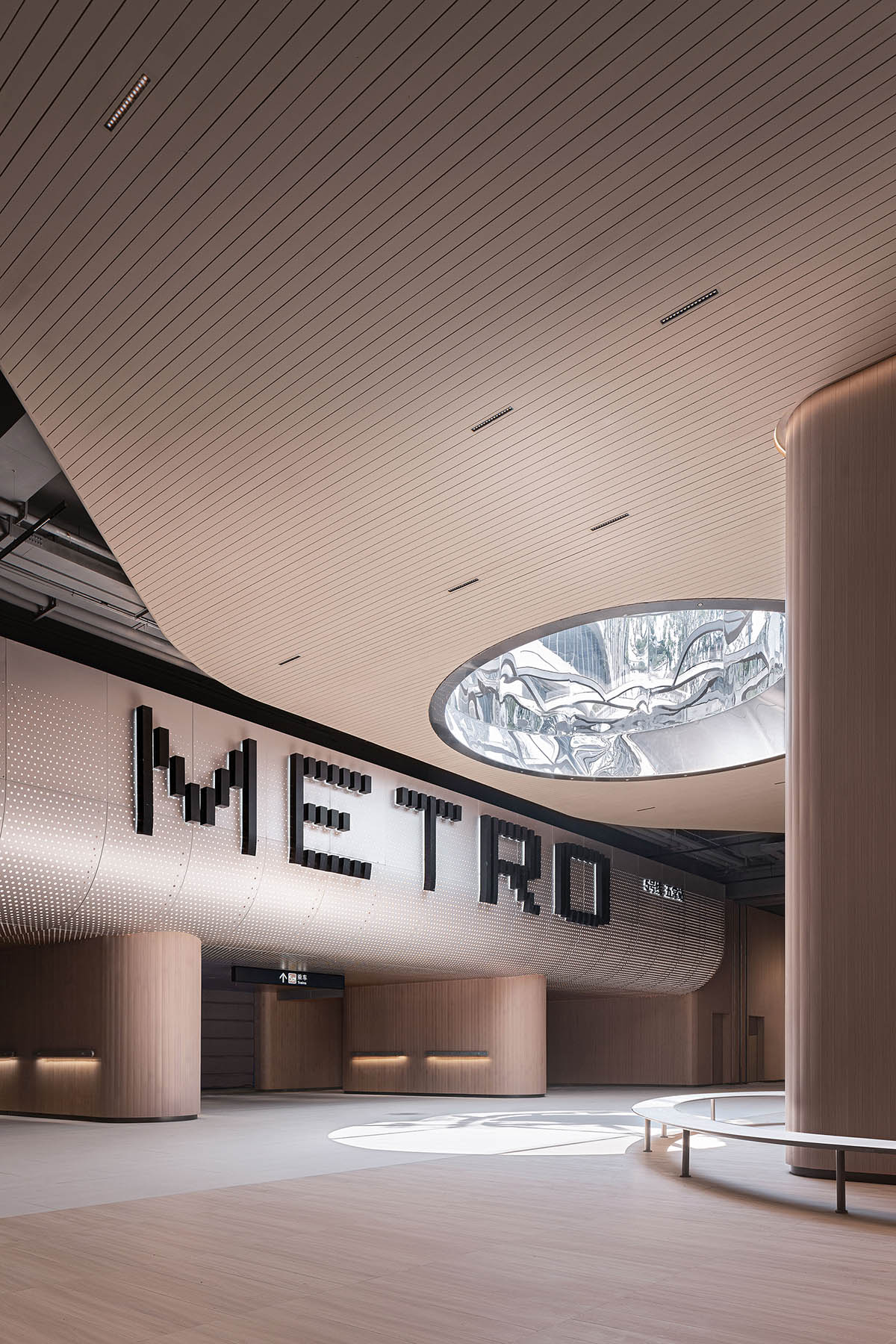 TOMO Design creates interiors for metro station with soft wood hues and circular light strip