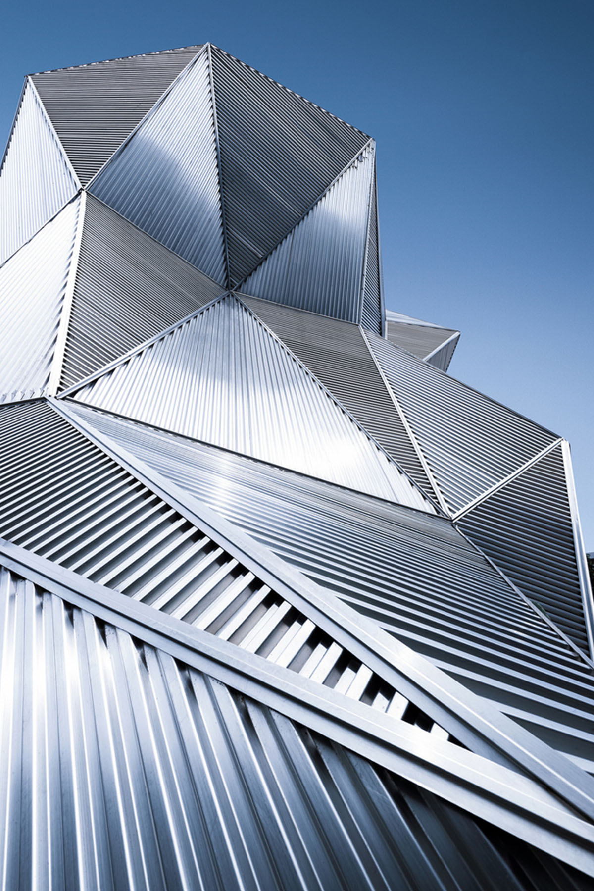 Angular corrugated stainless steel sheets form this showroom designed by PIG DESIGN in Hangzhou