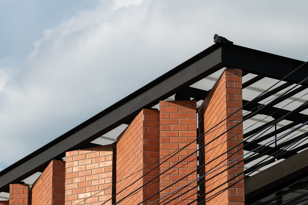 Gigantic terracotta-tile walls added to create a buffer zone in Pakkret House in Thailand