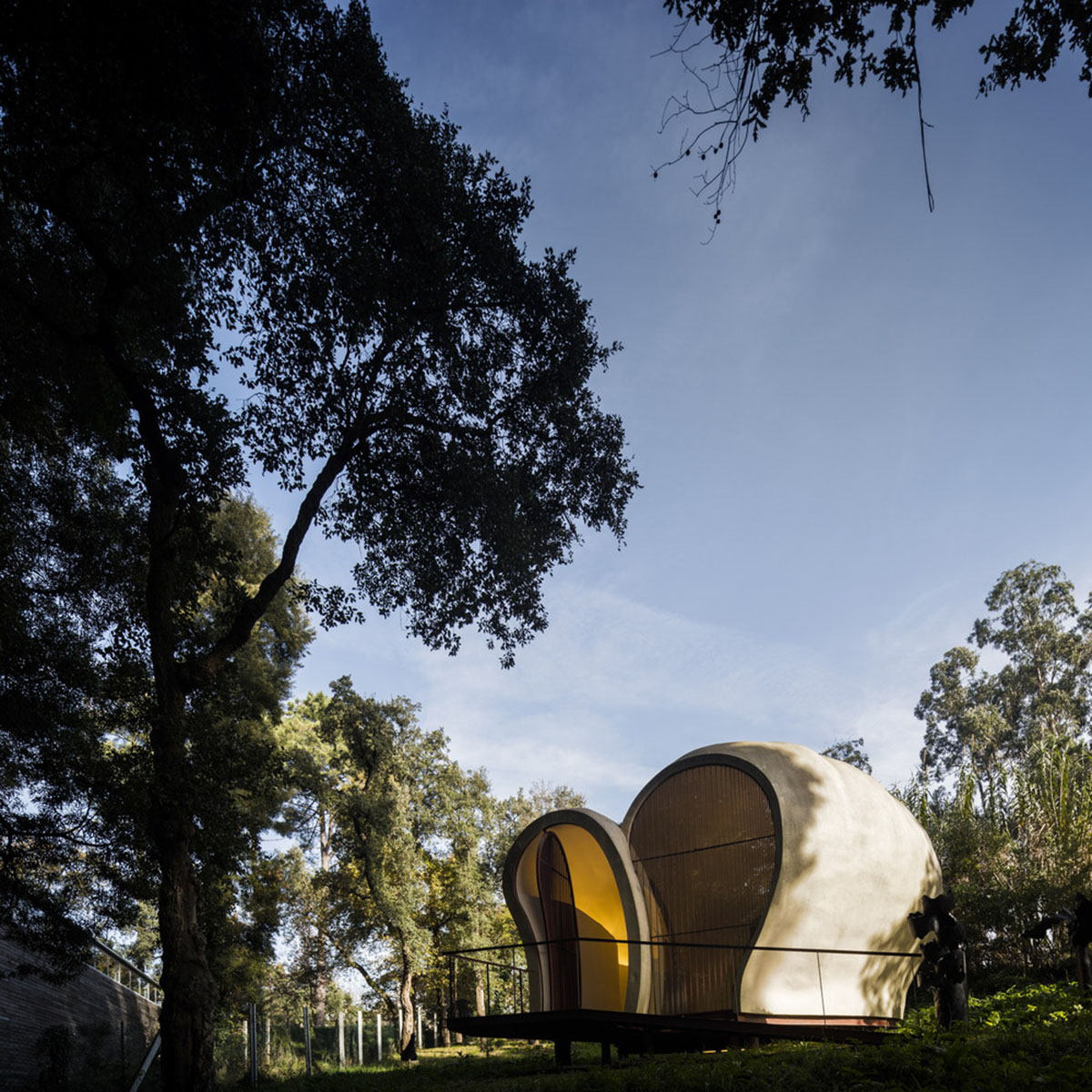 Super small cave-like art gallery by FCC Arquitectura built on lush green in Portugal