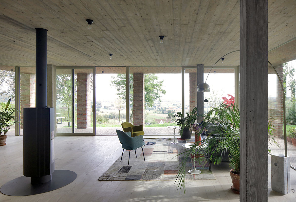 Studio Okami Architects built brick private villa embedded in the slope to offer infinite views