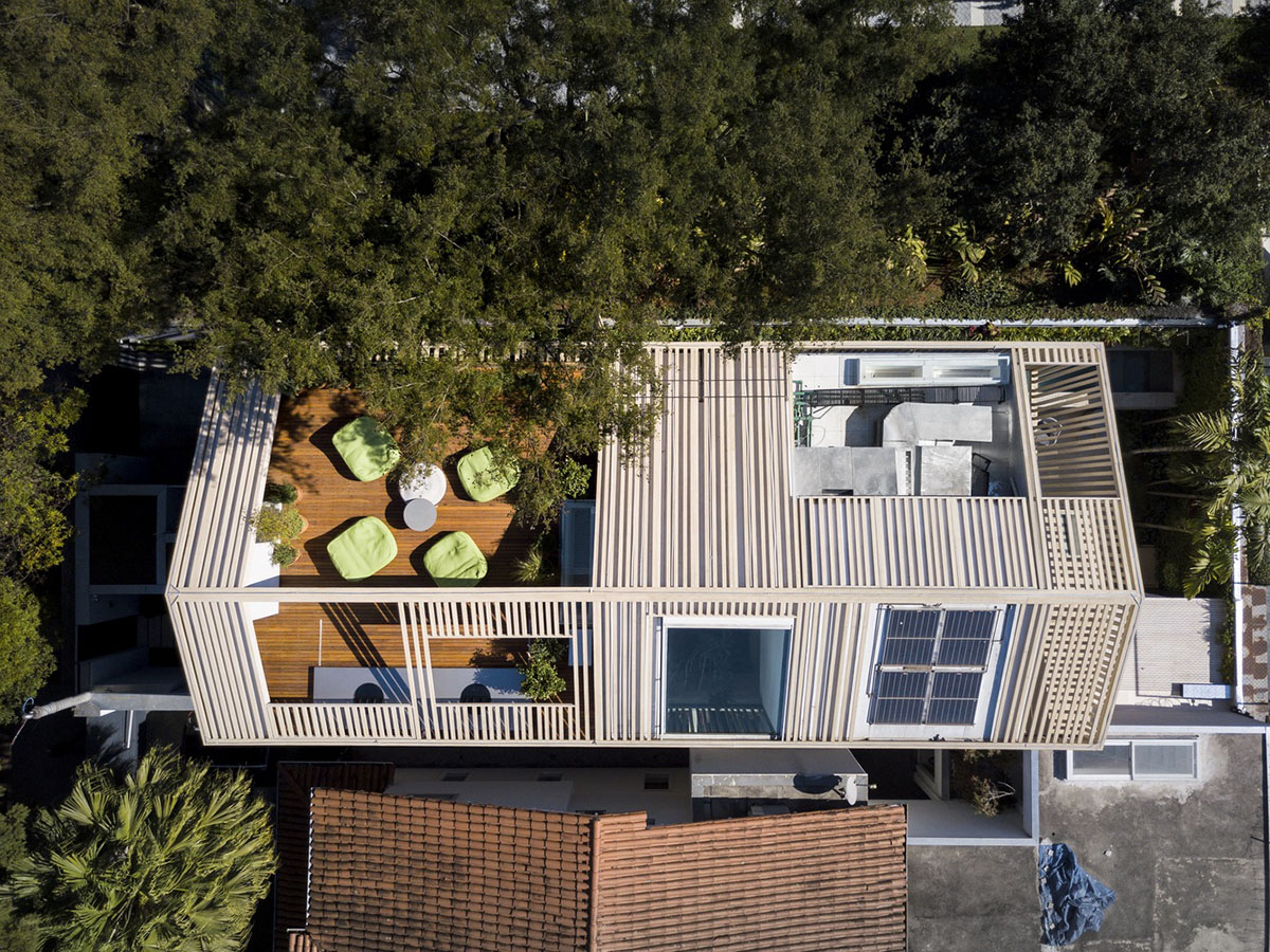 Studio AG designed large wooden residence featuring punctured volumes with gabled roof in São Paulo