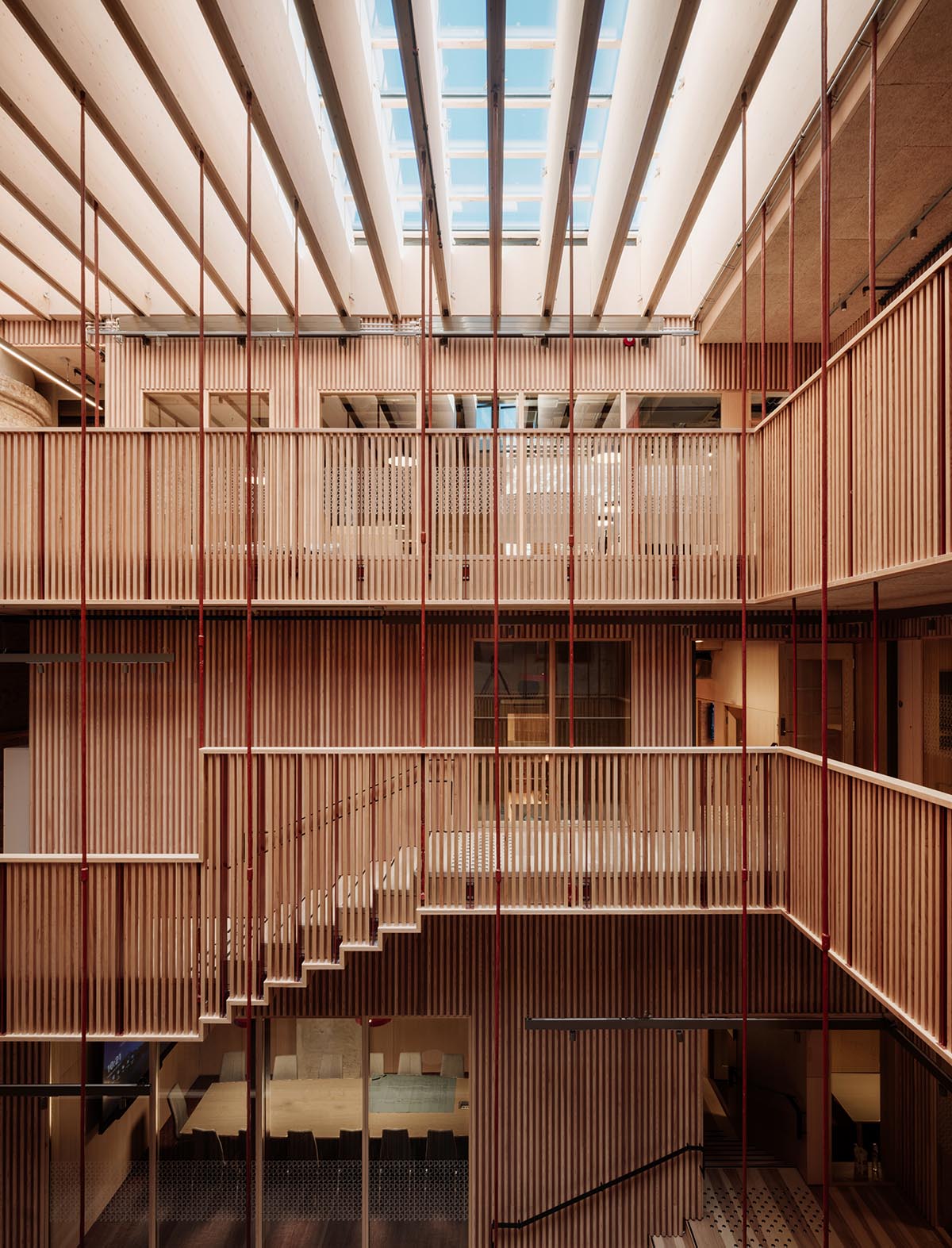 Atelier Oslo and KIMA Arkitektur restore former warehouse as a press house with light-lit atrium