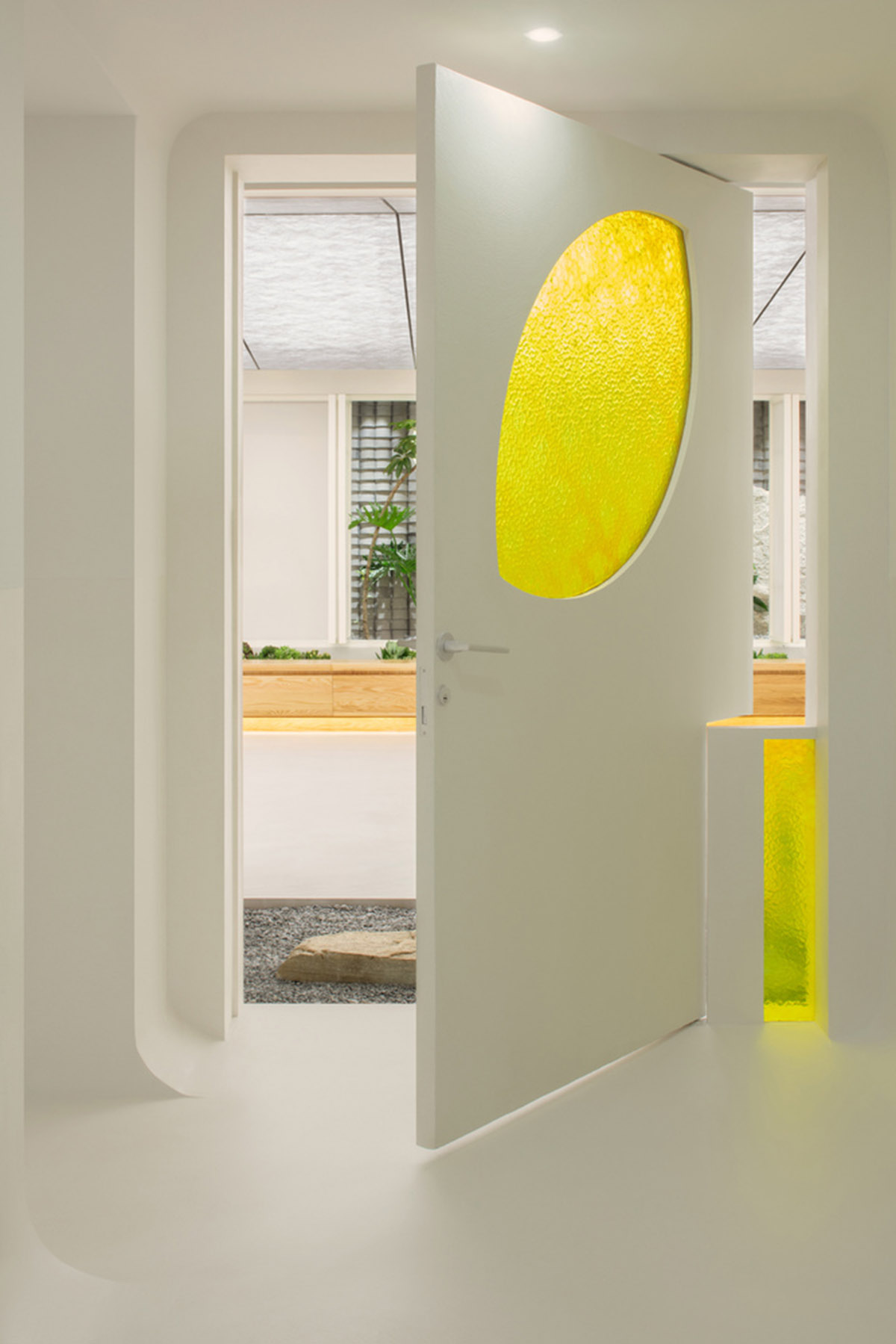 Jiejie studio wraps this tea room with a peach garden with rocky and forest landscape in Beijing