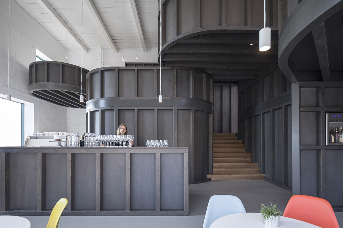 CHYBIK + KRISTOF converts historic brewery into House of Wine with rounded black volumes in Znojmo