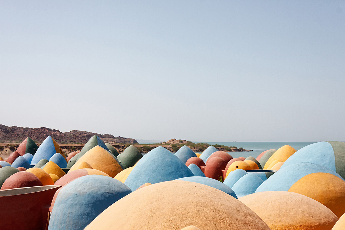 ZAV Architects built colorful-domed housing made of rammed earth and sand on Hormuz island, Iran