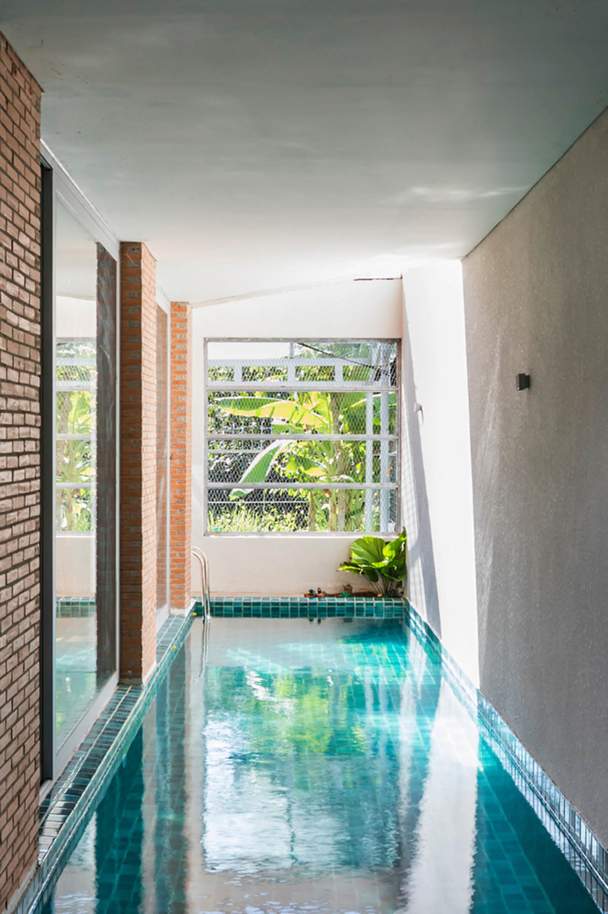 VTN Architects' new cascading family house creates large green gardens in a narrow site of Vietnam