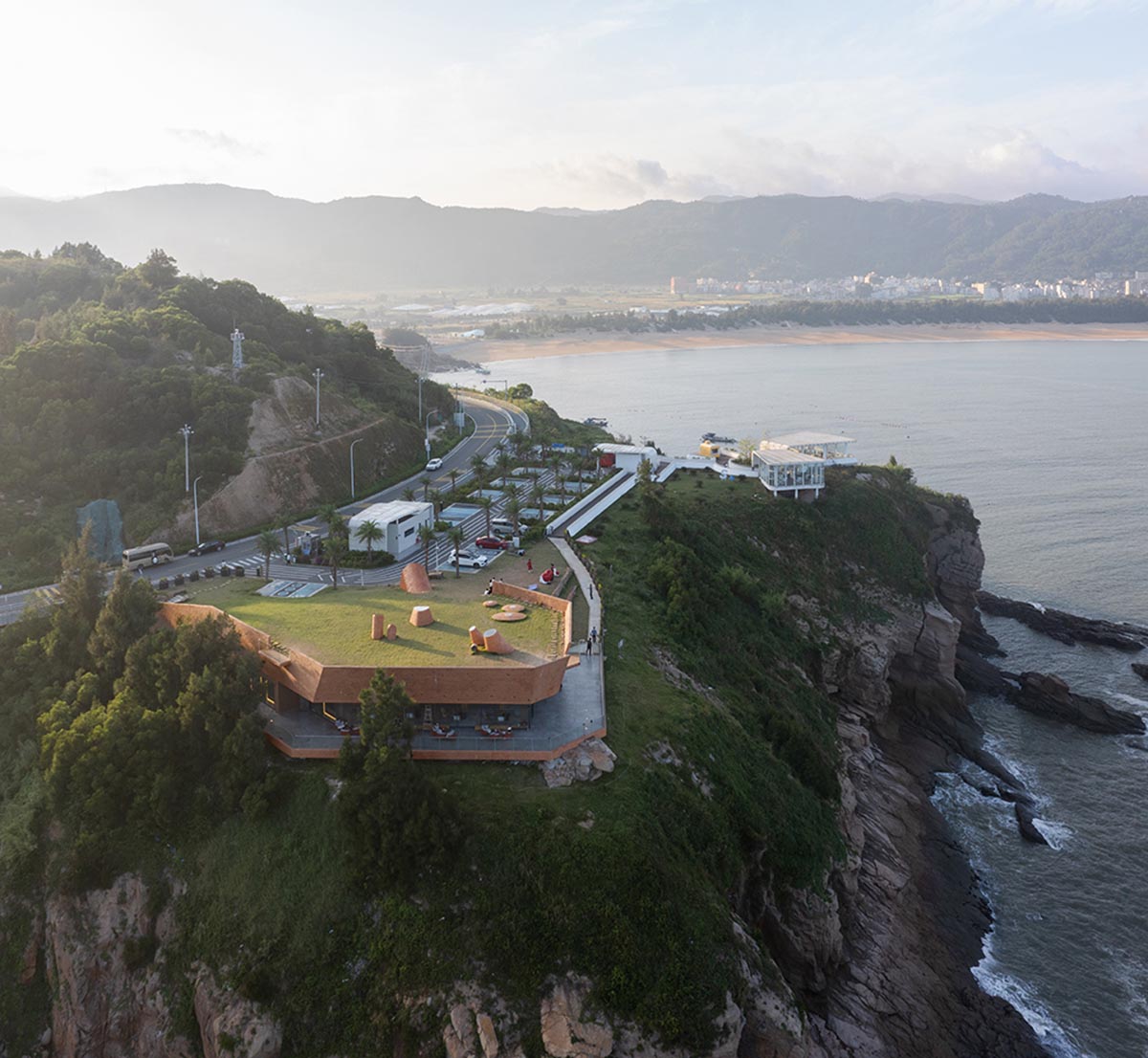 A gallery on a cliff features irregularly shaped lighting tubes that mimic marine creatures in China