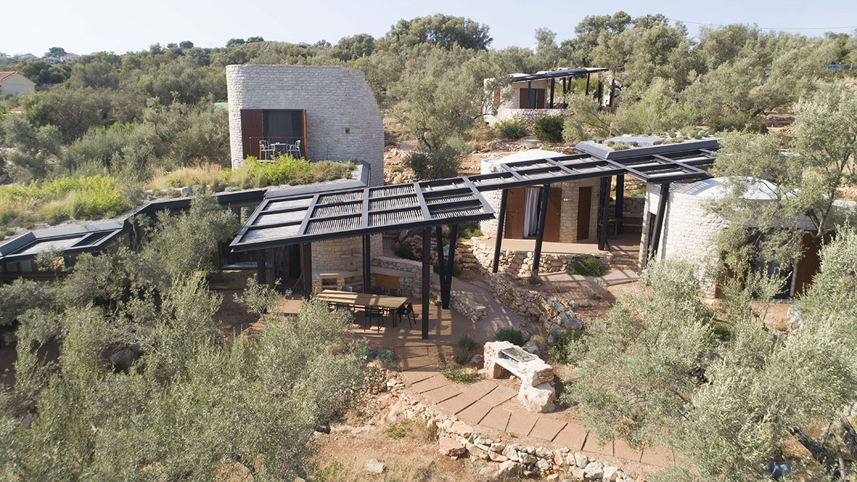 Pastoral round stone dwellings inform Meganisi House by Hiboux Architecture on Meganisi island