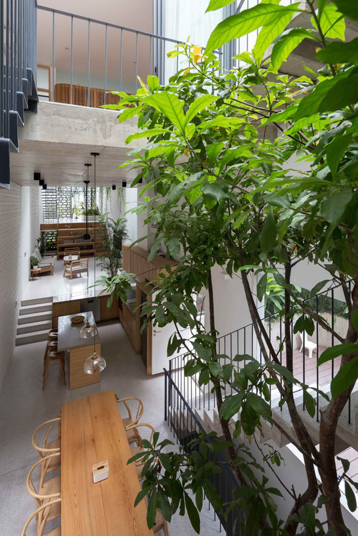 ODDO architects built this narrow house with rich interior spaces and perforated skin in Hanoi