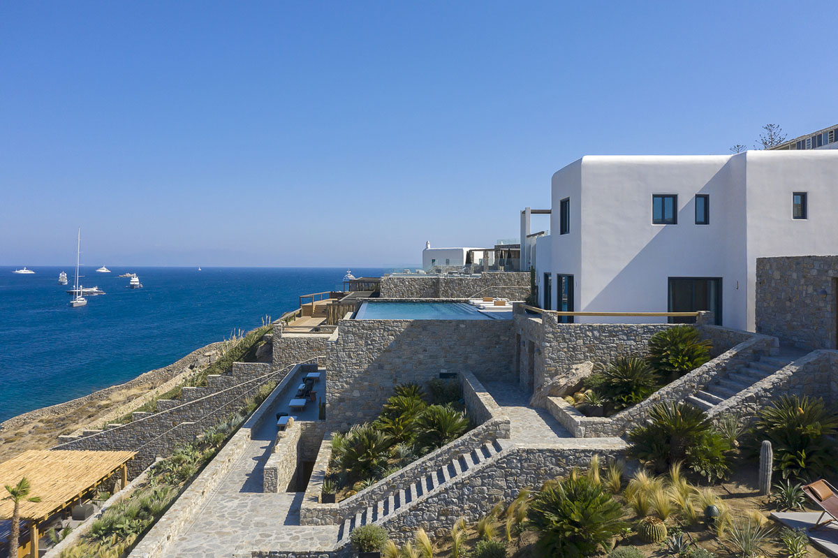 MK Design Studio designs luxurious holiday villa with creamy white walls  and stone-walled terraces