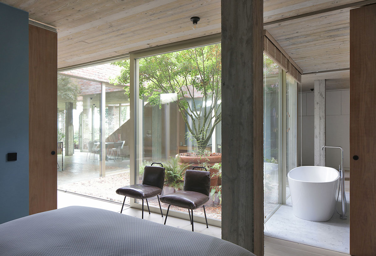 Studio Okami Architects built brick private villa embedded in the slope to offer infinite views