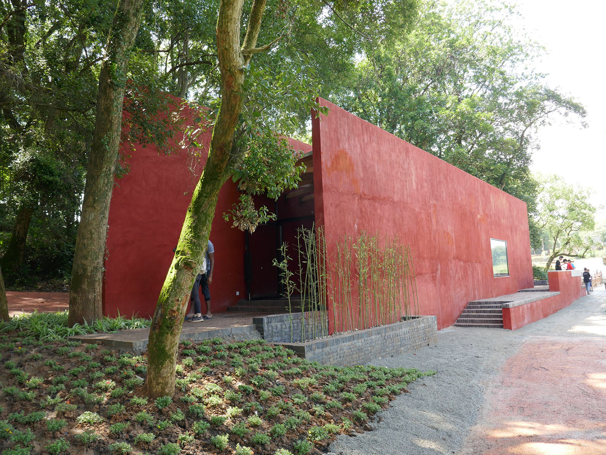 Children attend teaching courses in between red-colored free standing walls in rural village of China