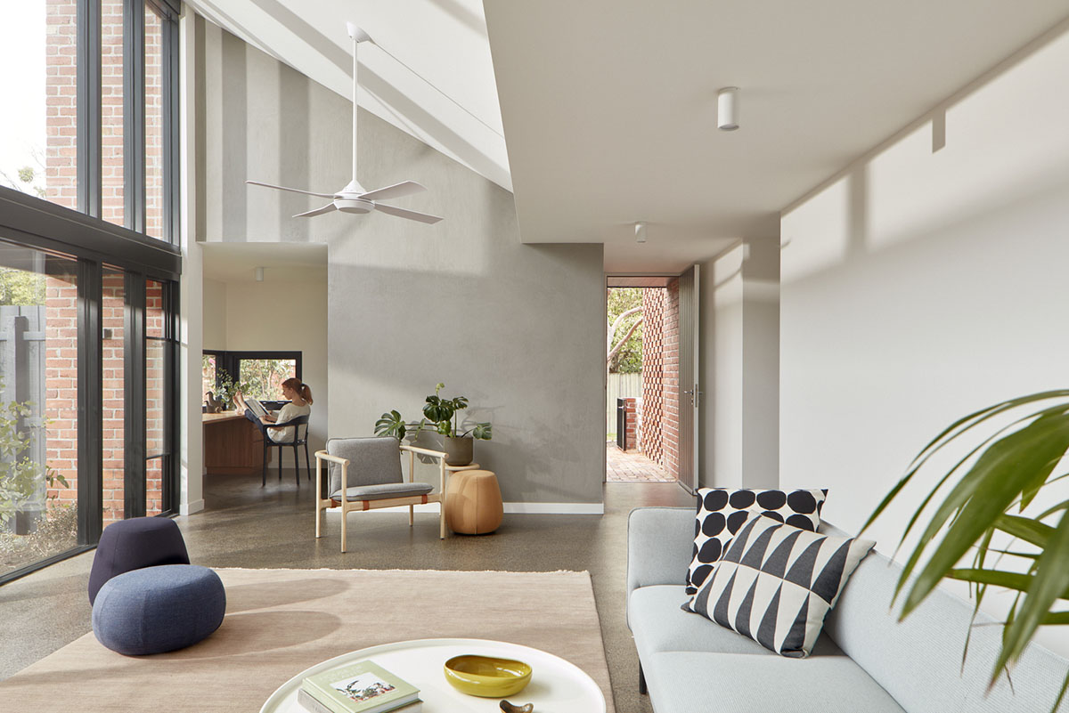 Recycled brick screens wrapping these two dwellings help thermal comfort in a suburb of Australia