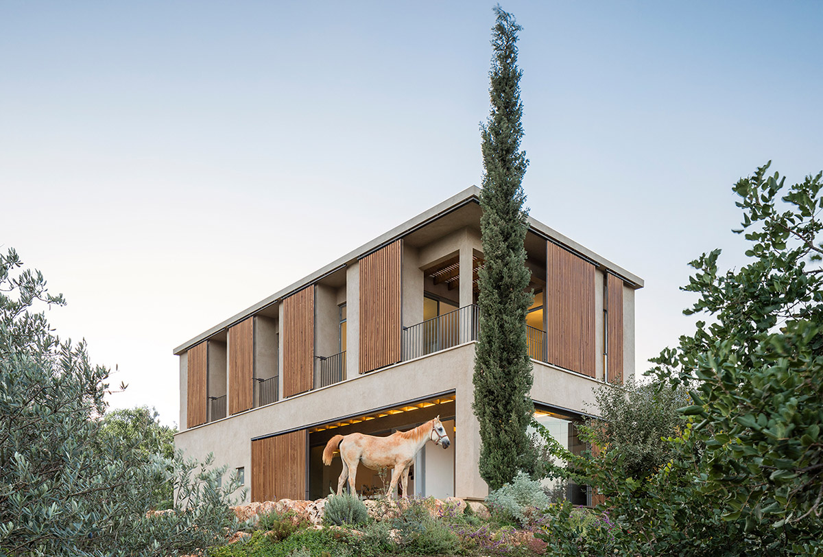 Golany Architects completes concrete private residence with wooden shutters in the Galilee