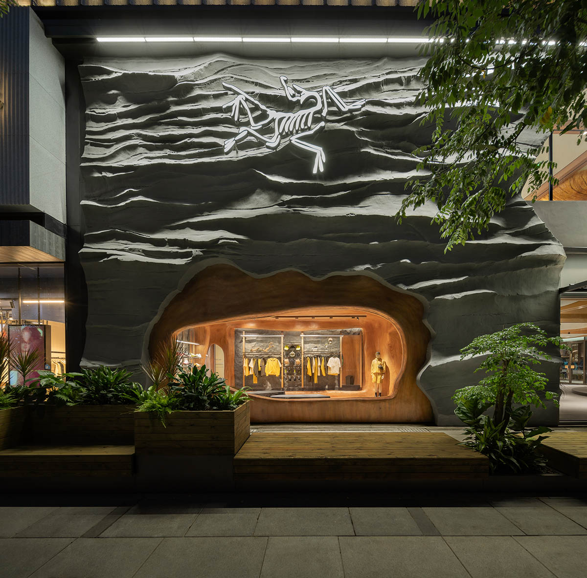 STILL YOUNG creates cave-like interiors for a store with wood and rock elements in Beijing 