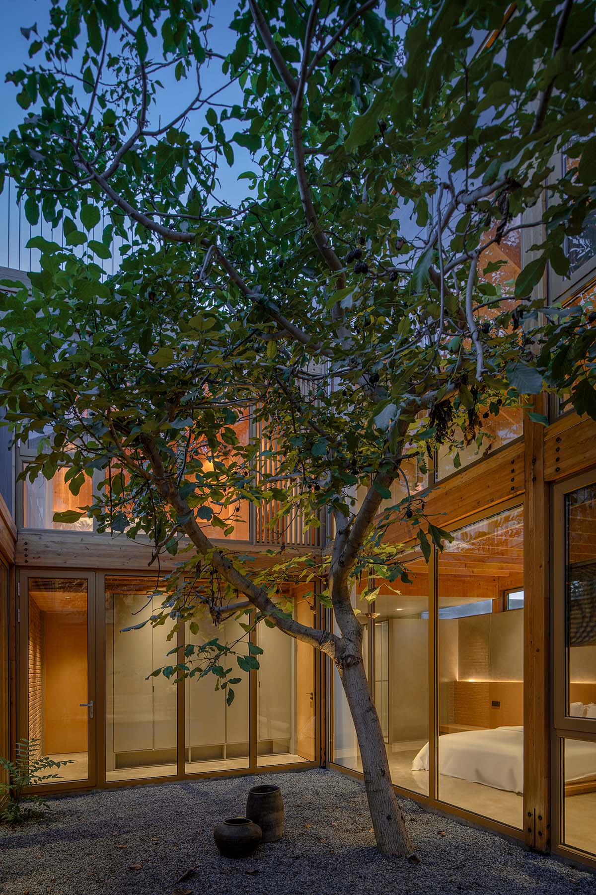 Archstudio renovates traditional Beijing courtyard house with interwoven wooden framework