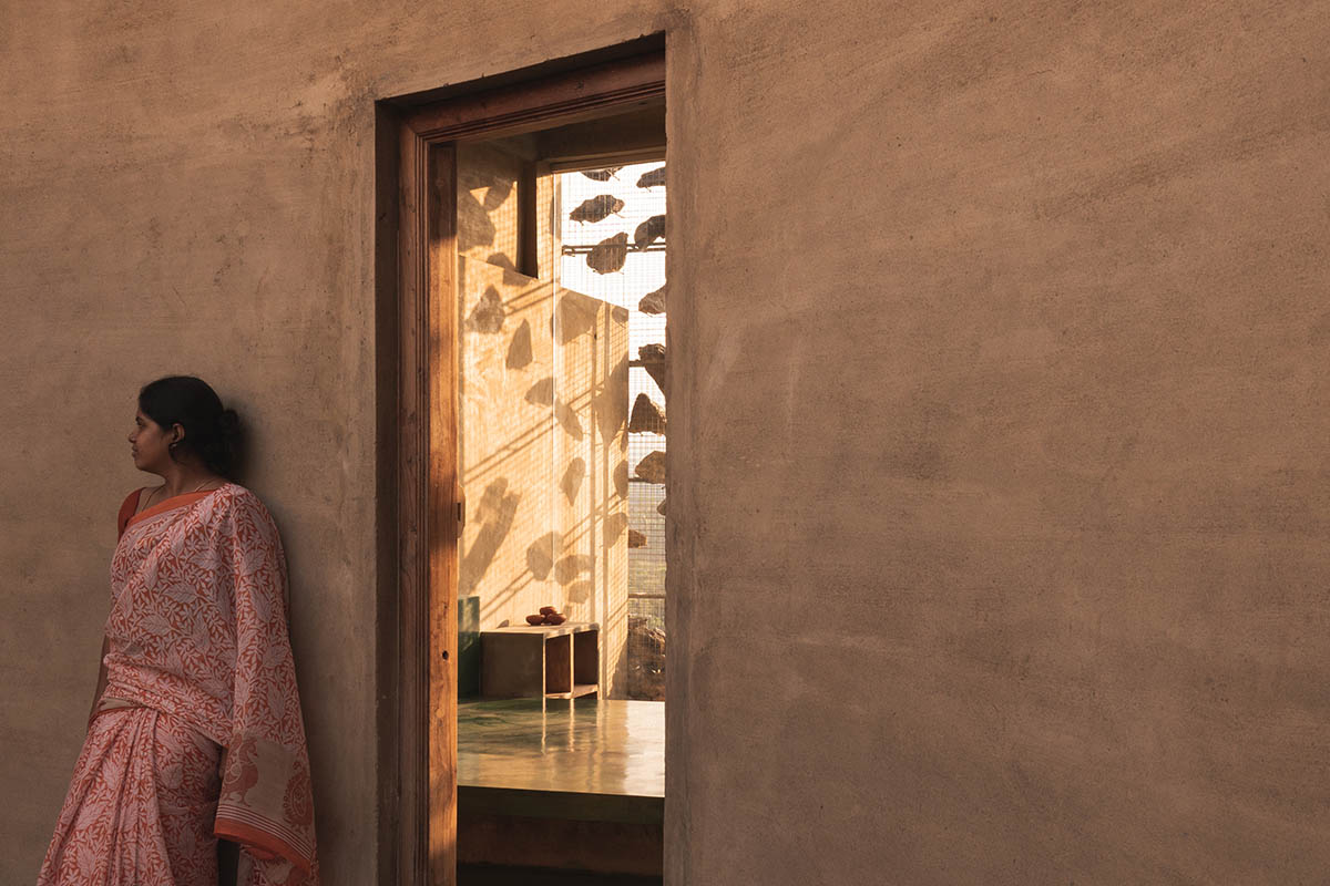 Farm house by Earthscape Studio is wrapped by gabion wall to filter light and airflow in India 