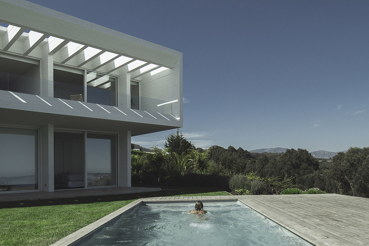 Cristián Romero Valente built this white concrete house on steep