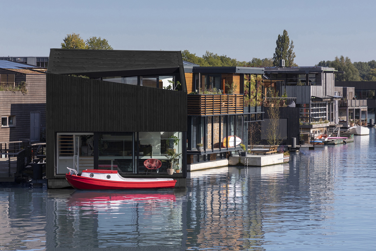 I29 Built Floating House With Black Timber And Cut-out Roof As Part Of 