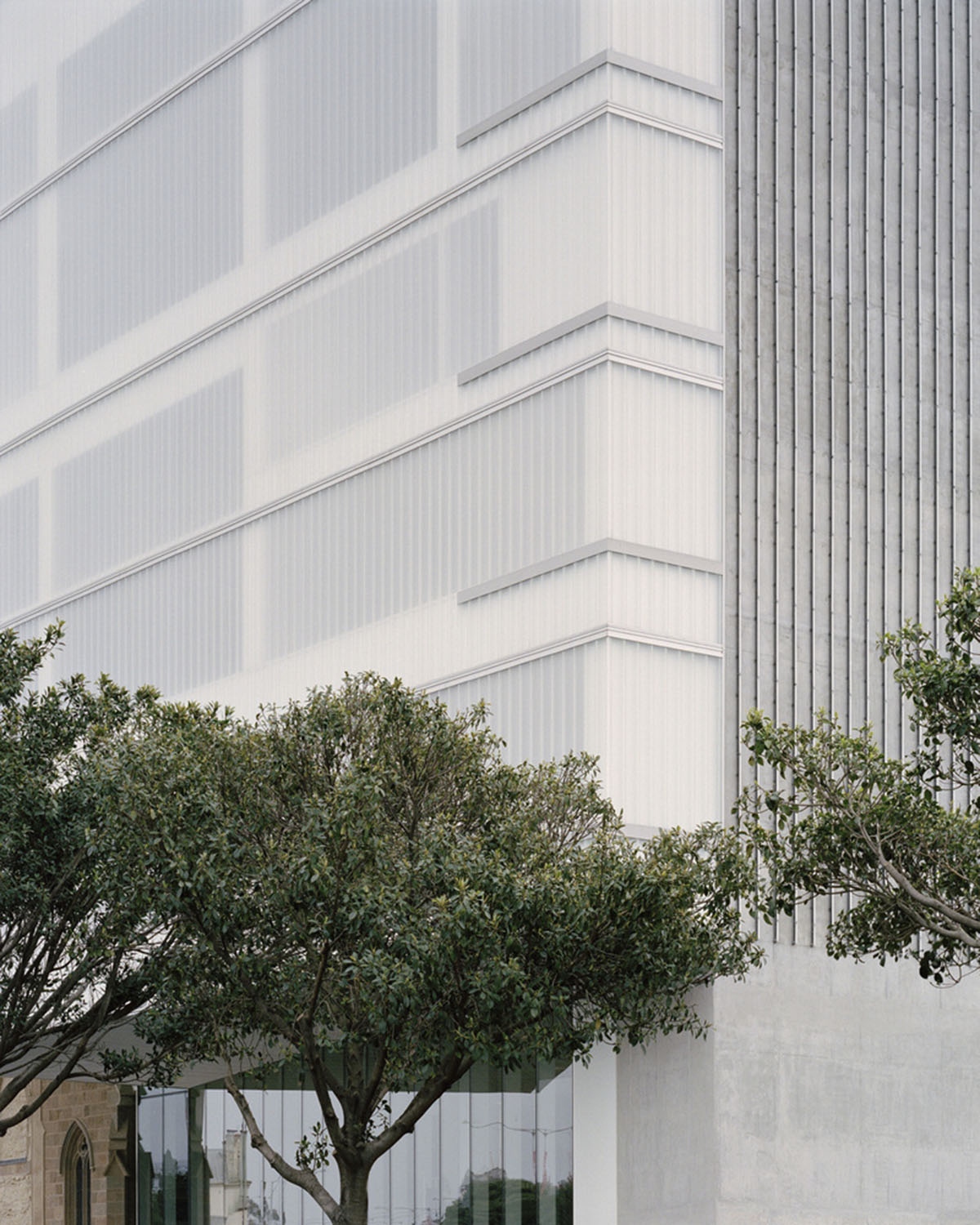 Hassell reveals Arts Centre with sliced translucent volume which is in dialogue with historic church