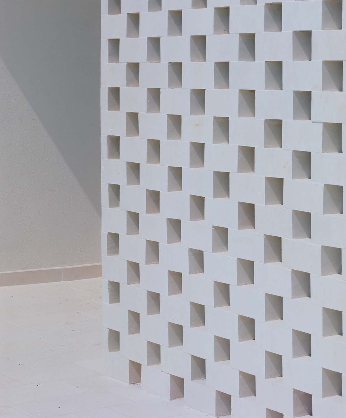 Rural retreat filters light through its stone porous screen in the Salento countryside