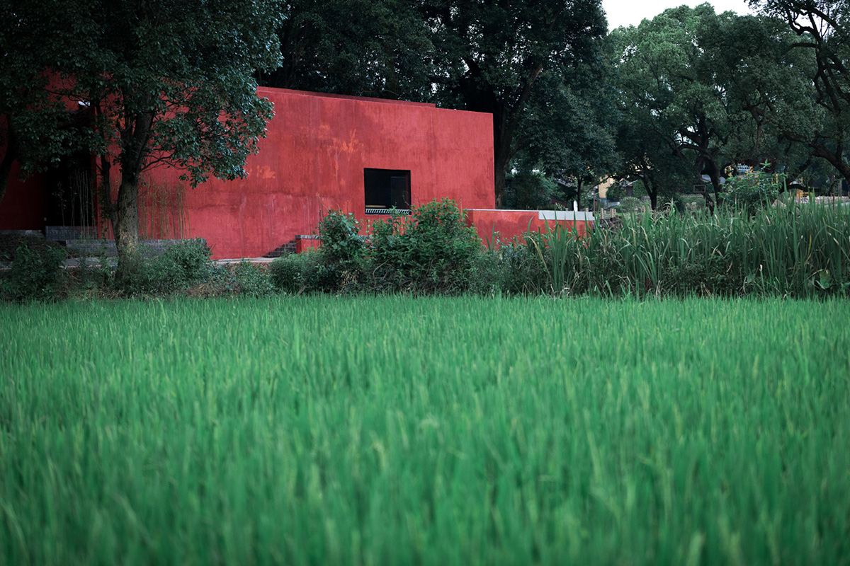 Children attend teaching courses in between red-colored free standing walls in rural village of China