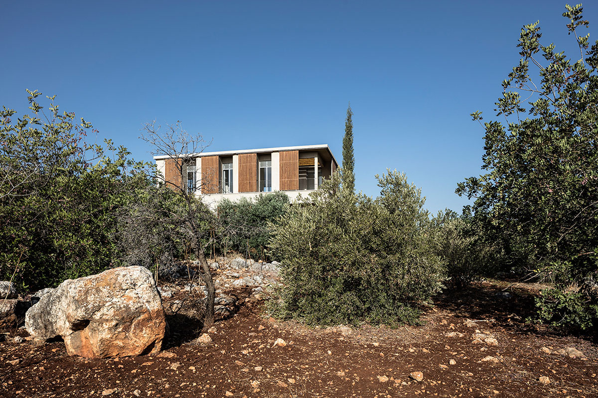 Golany Architects completes concrete private residence with wooden shutters in the Galilee