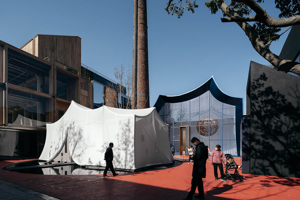 Wutopia Lab converts old roof-covered stockyard and duty room into wave-shaped community hub