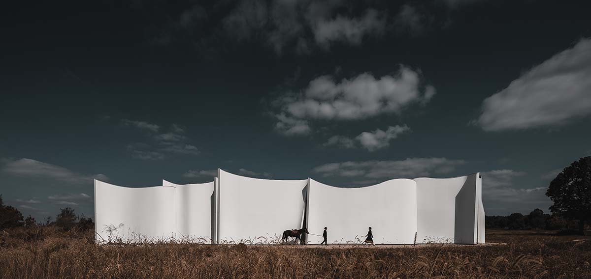 Chinese chapel creates a fluid silhouette featuring curving walls to mimic blossoming petals 