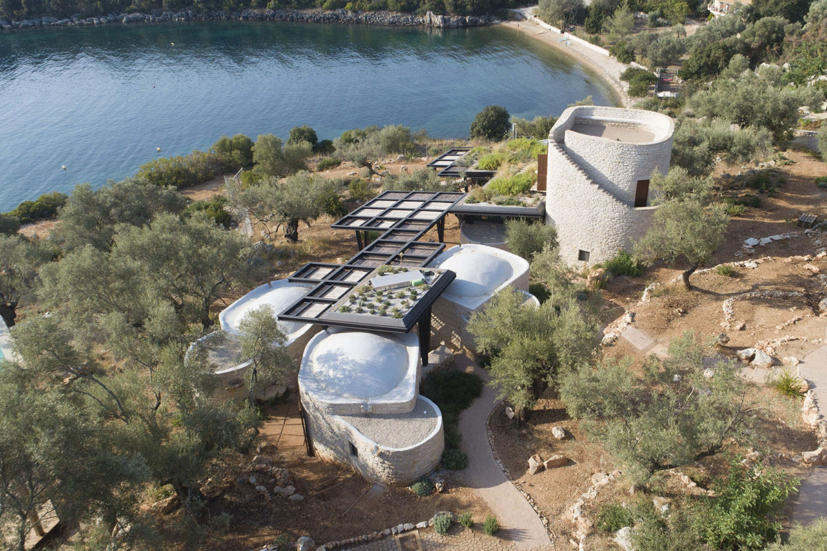 Pastoral round stone dwellings inform Meganisi House by Hiboux Architecture on Meganisi island