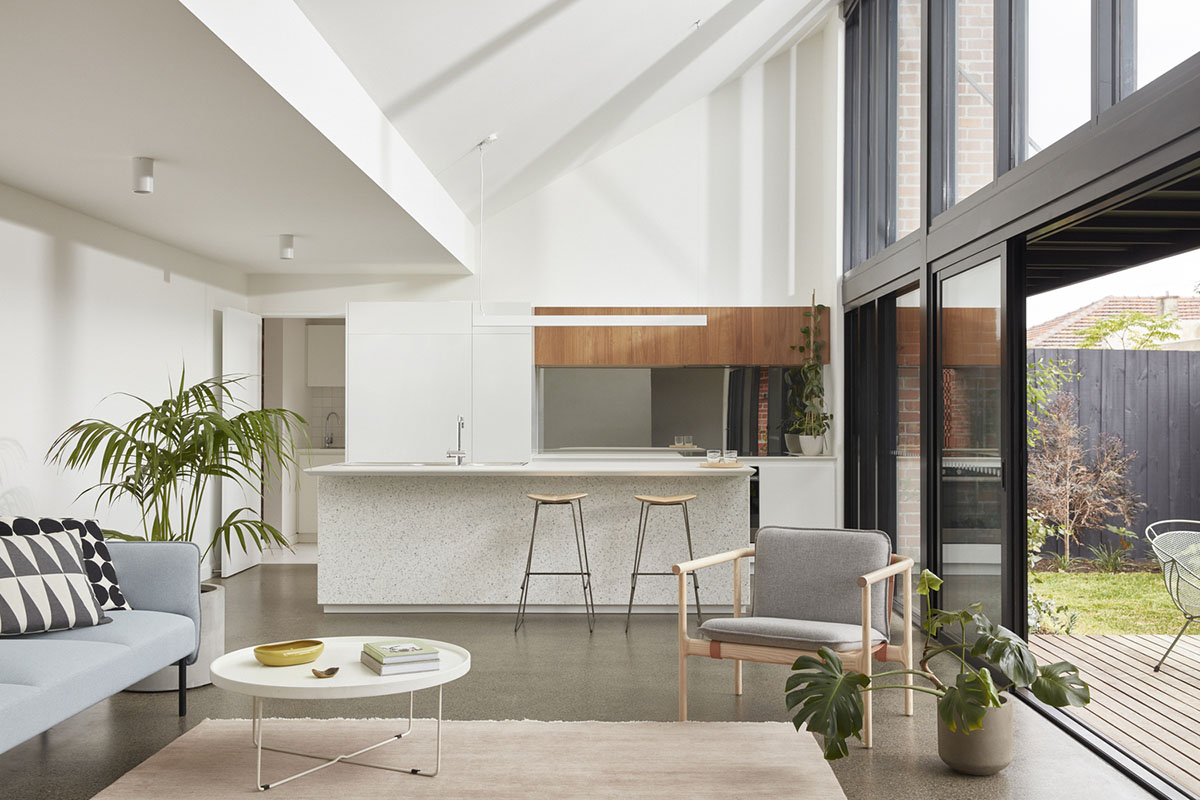 Recycled brick screens wrapping these two dwellings help thermal comfort in a suburb of Australia