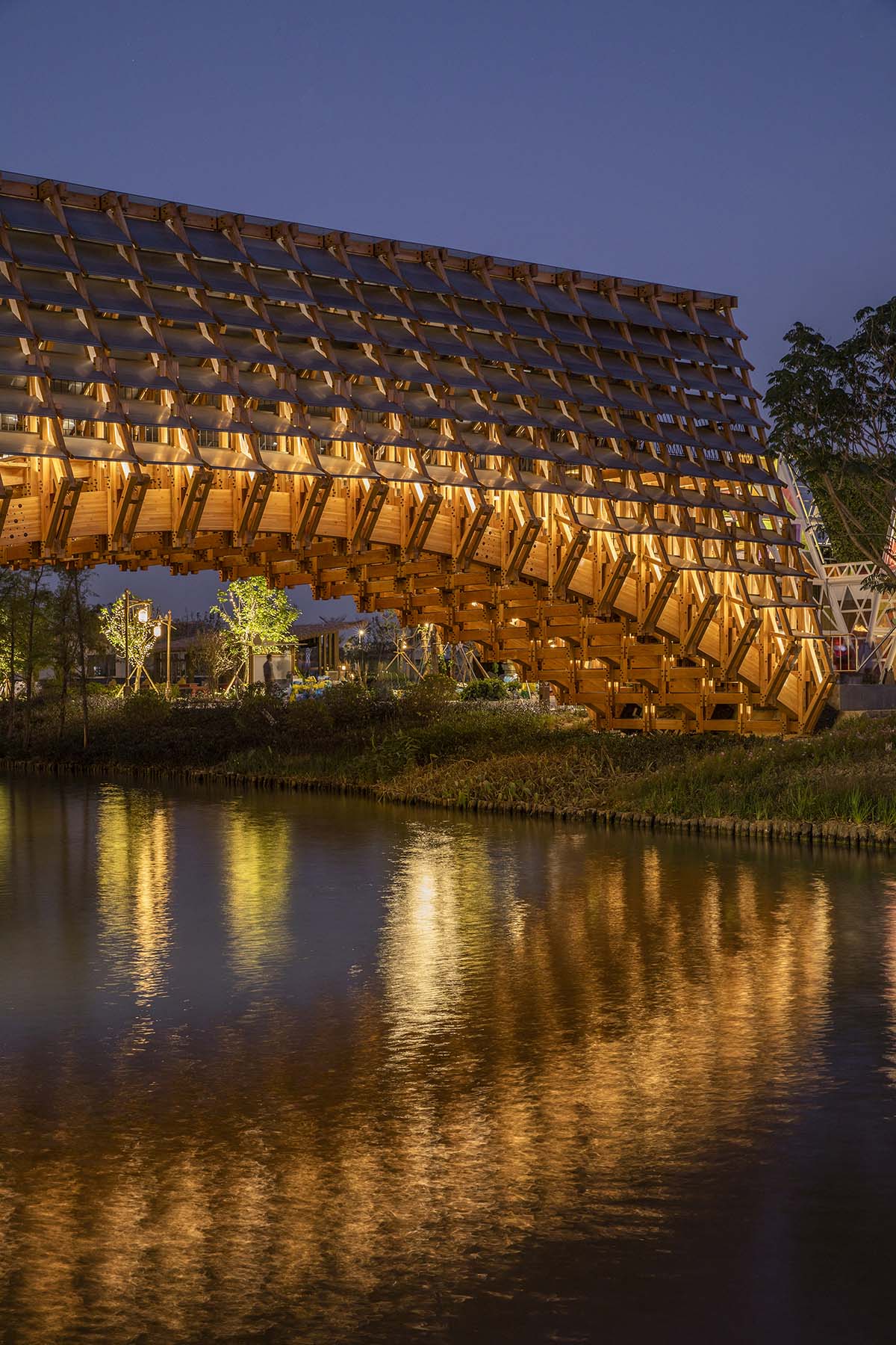 Arched timber bridge by LUO studio allows boats to pass under bridge smoothly in Gulou waterfront