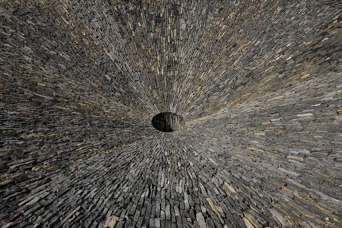 This 2,4-metre trumpet-flower-shaped sinkhole sustains rain fall cycles of Chinese old village