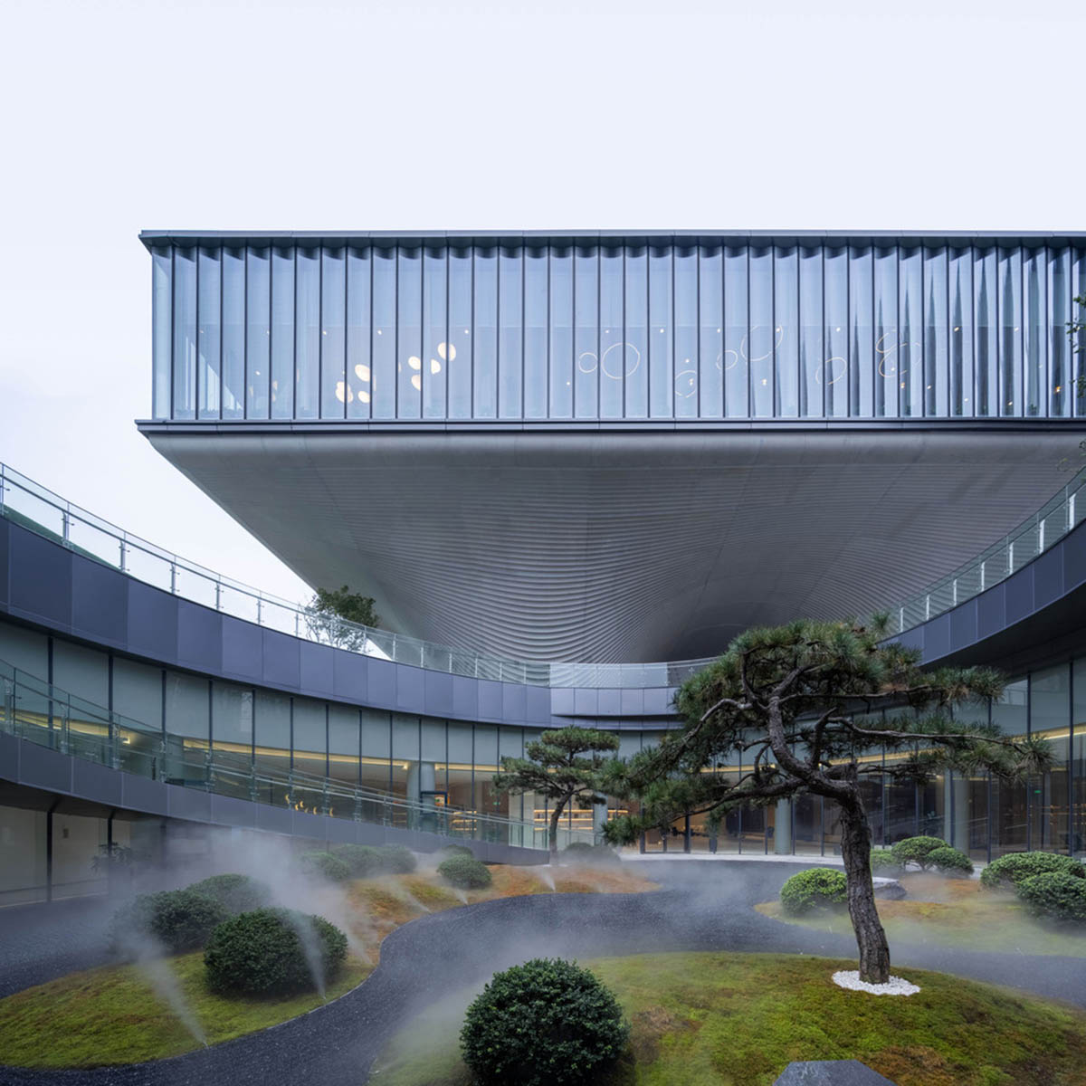 Community Center in Xi’an is raised on sculptural base that features a rippling effect