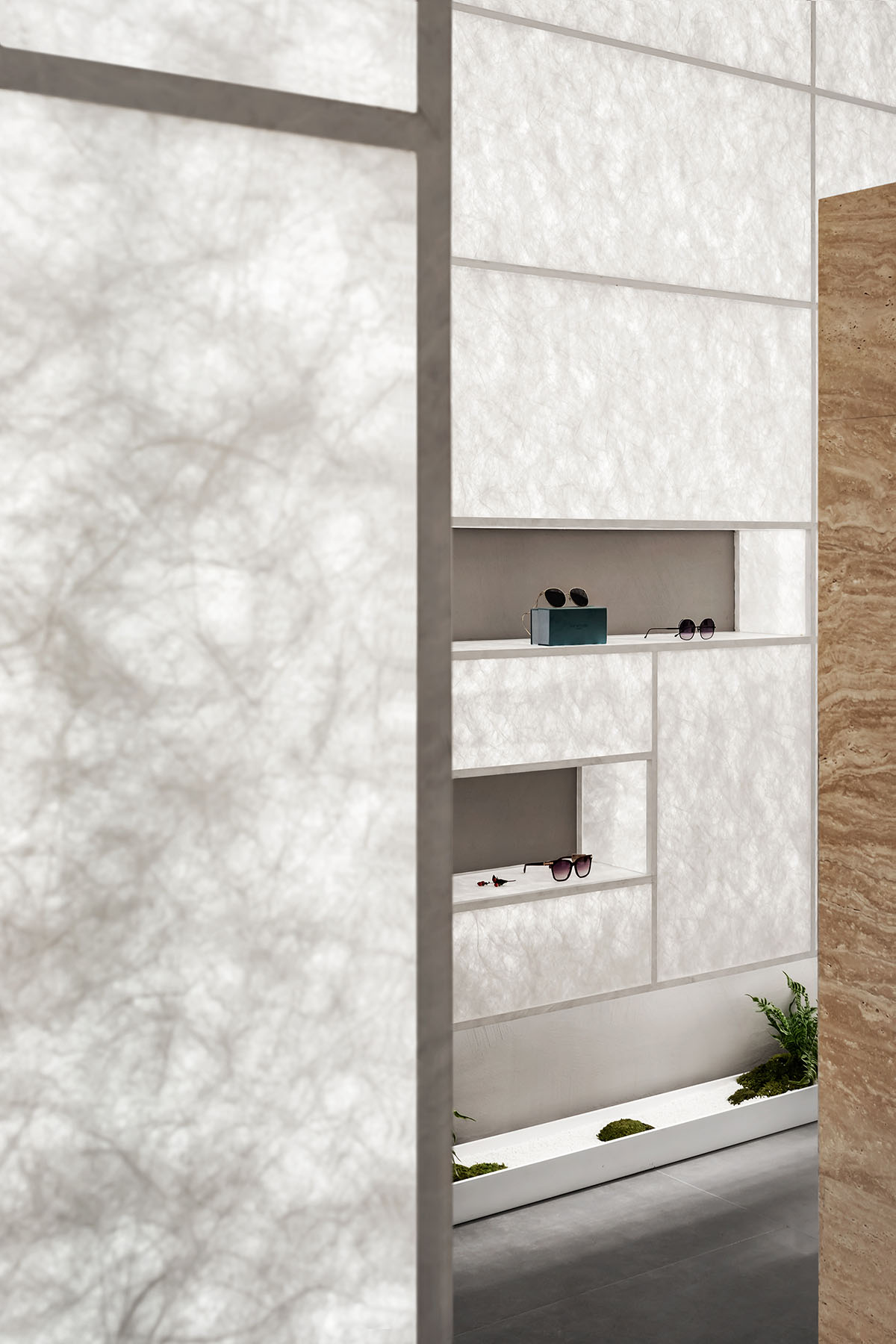 Luminous screen walls create fluid interiors for an optic store designed by Onexn Architects 