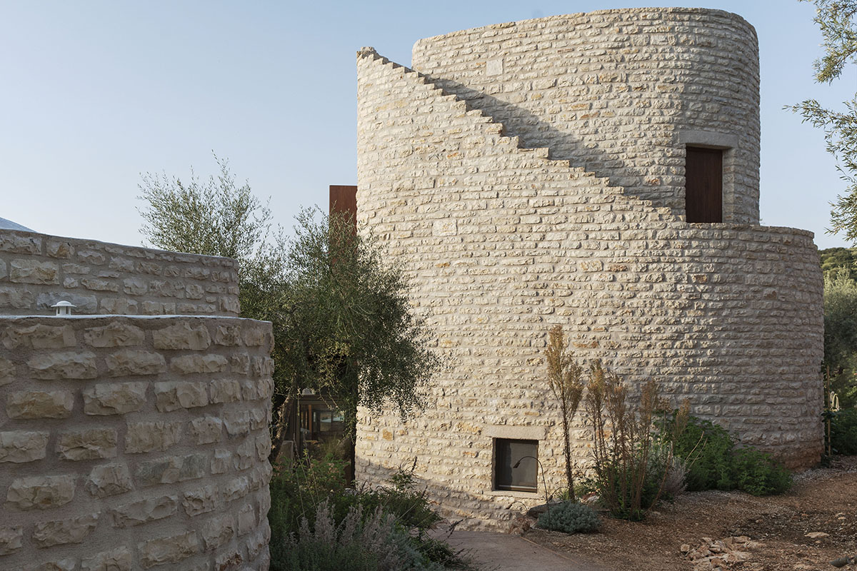 Pastoral round stone dwellings inform Meganisi House by Hiboux Architecture on Meganisi island