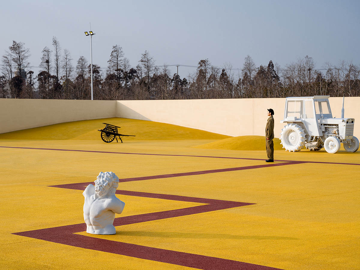 Wutopia Lab converts abandoned barnyard into a golden yellow field resembling a frozen harvest time