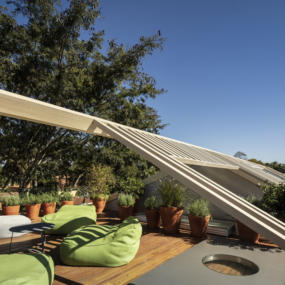 Studio AG designed large wooden residence featuring punctured volumes with gabled roof in São Paulo