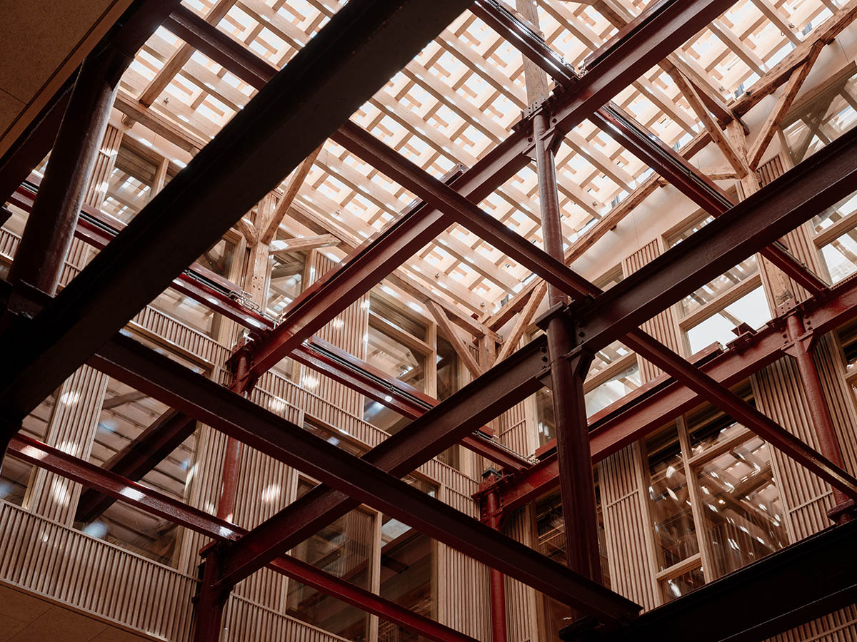 Atelier Oslo and KIMA Arkitektur restore former warehouse as a press house with light-lit atrium