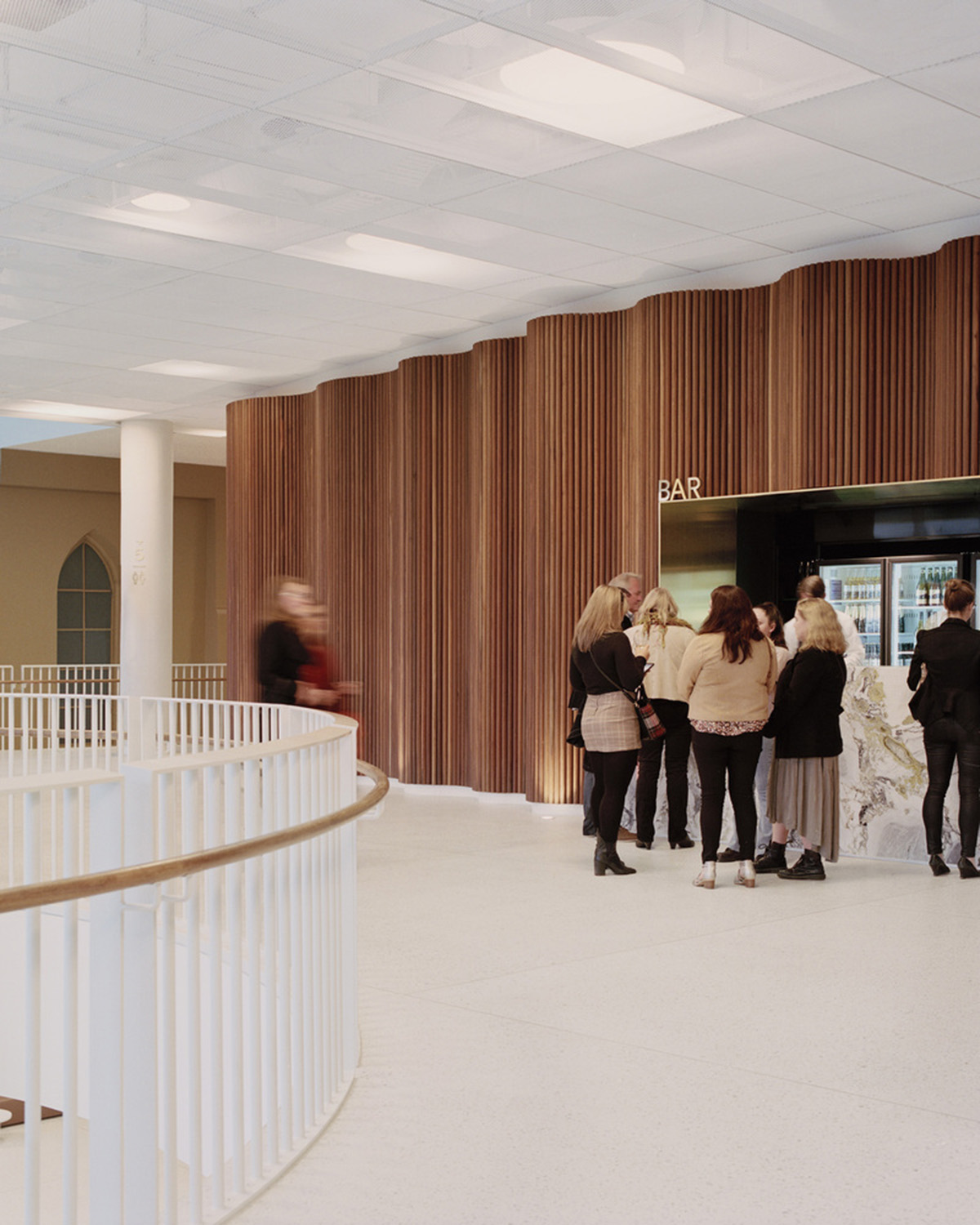 Hassell reveals Arts Centre with sliced translucent volume which is in dialogue with historic church