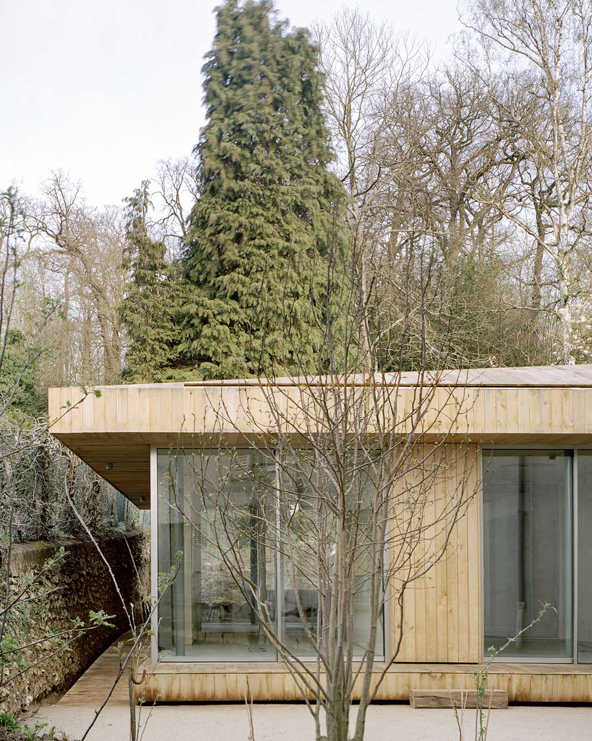 Atelier Delalande Tabourin creates a wooden sunken pavilion that arouses curiosity for visitors