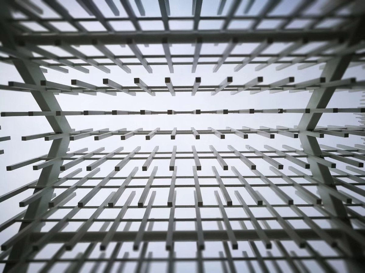 A church made of thousands of white thin beams looks like suspended in the air in lavender field