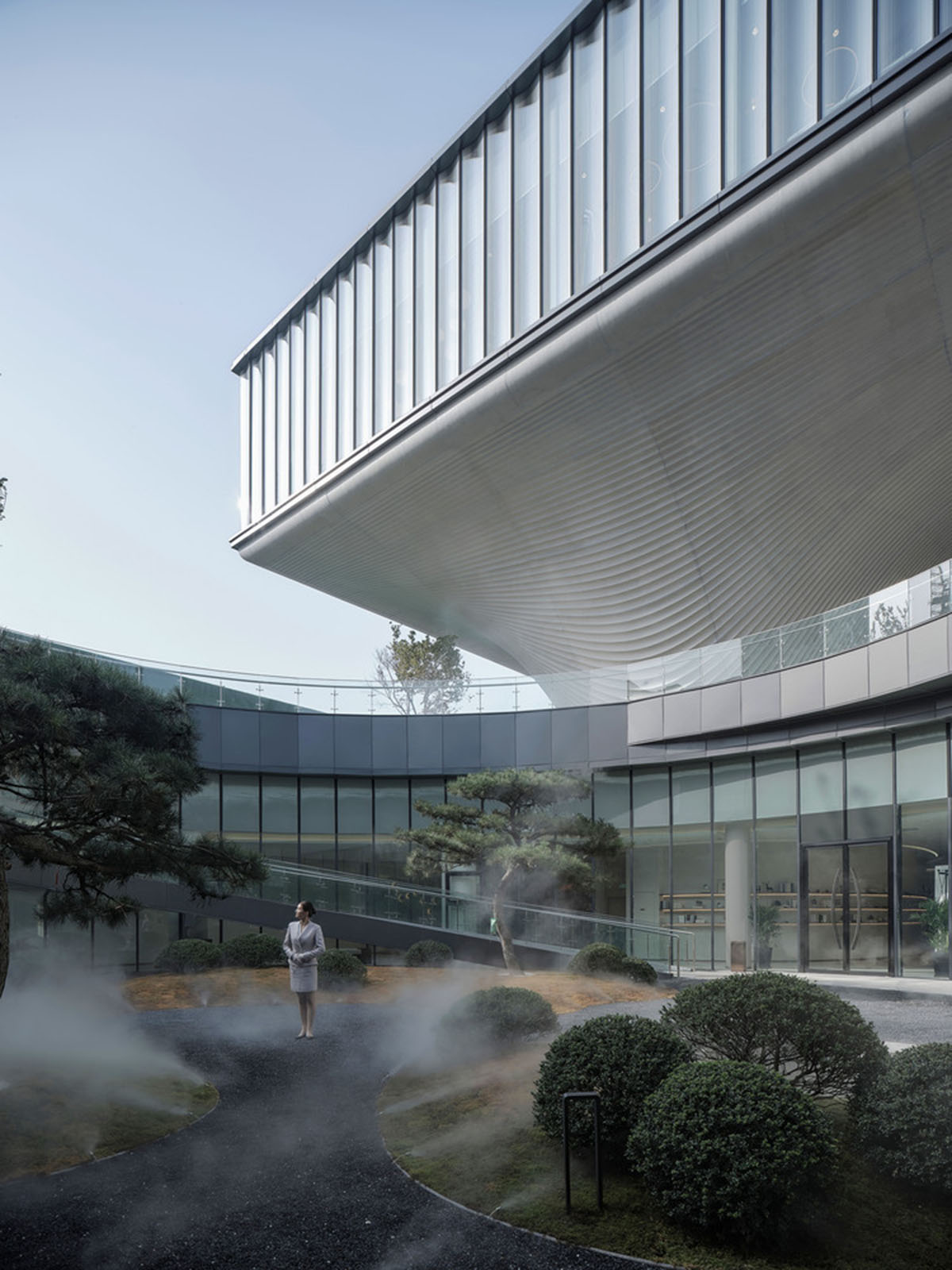 Community Center in Xi’an is raised on sculptural base that features a rippling effect