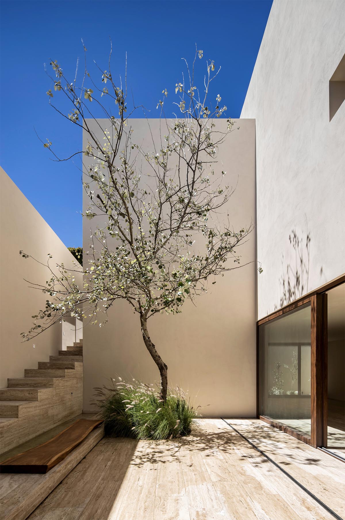 Sabino 10 residence by Editorial features a solid façade with hermetic volumes in Mexico